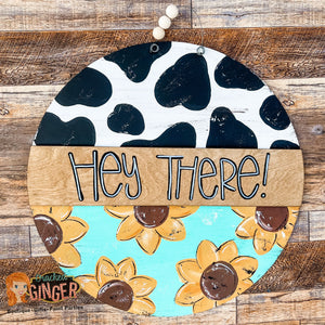 Cow print and Sunflowers Hey There Round Door Hanger Sign